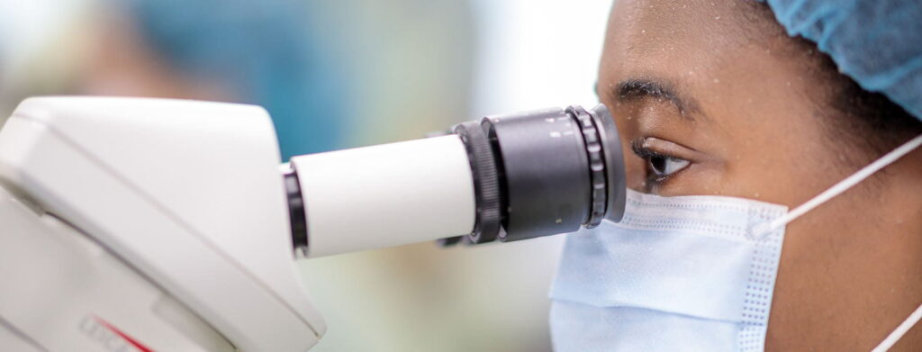 Woman looking through a microscope