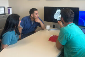 photo of surgeons reviewing CT scan