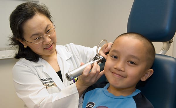 Otolaryngologist Judith Lieu examines ear of patient Benton Uong