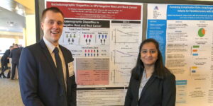 Med students pose with Triologic poster