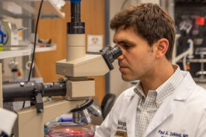 photo of Paul Zolkind at the microscope