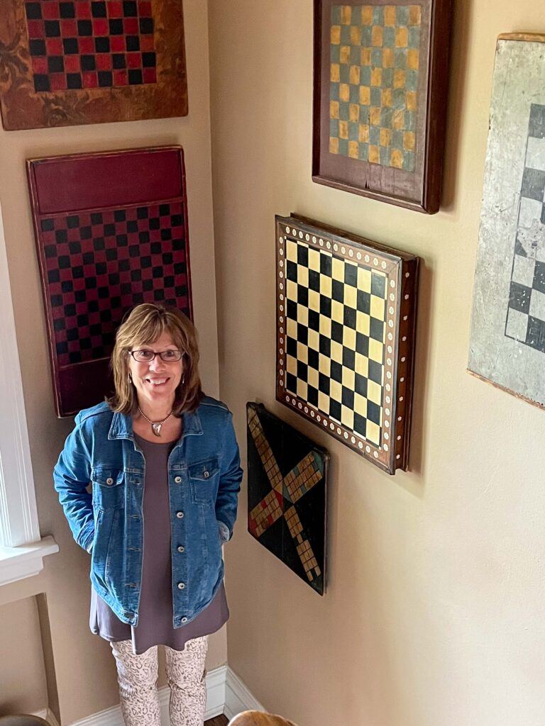 photo of Jill Firszt with antique gameboards