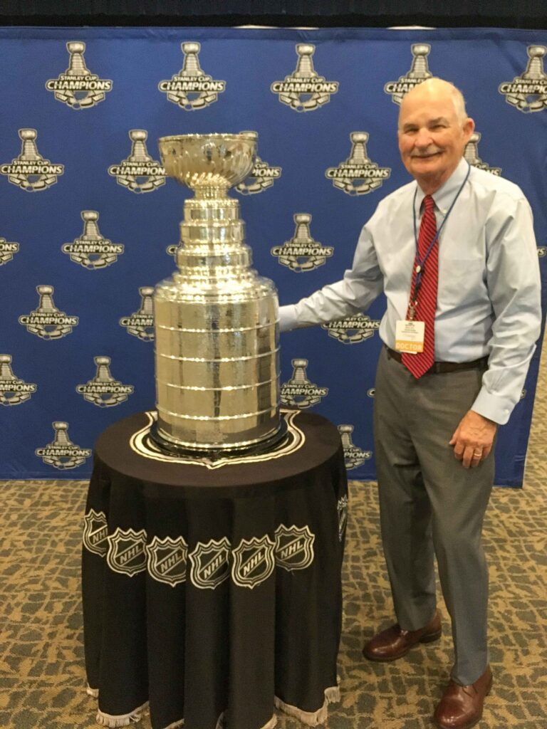 Photo of Dr. Moritz with Stanley Cup trophy.