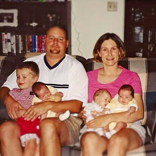 photo of Deb and Jim with arms full of kids