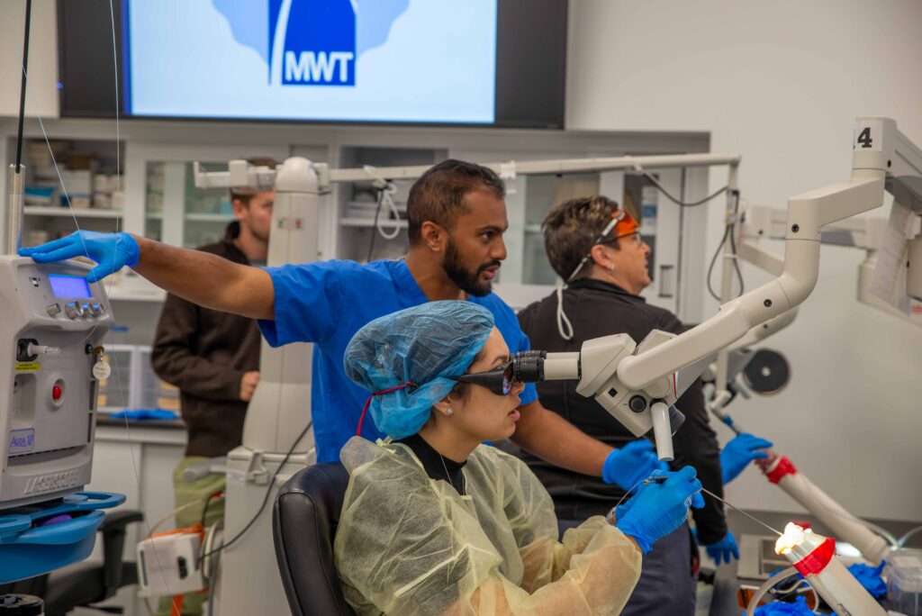 ENT resident Holly Sprow practices laser techniques under the guidance of Associate Professor of Otolaryngology Bharat Panuganti, MD.